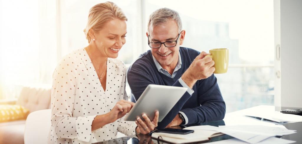 Couple reviewing documents on tablet Couple reviewing documents on tablet