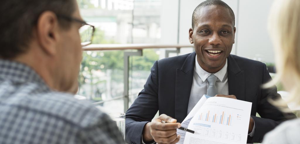 Financial advisor meeting with clients about their investment goals Financial advisor meeting with clients about their investment goals