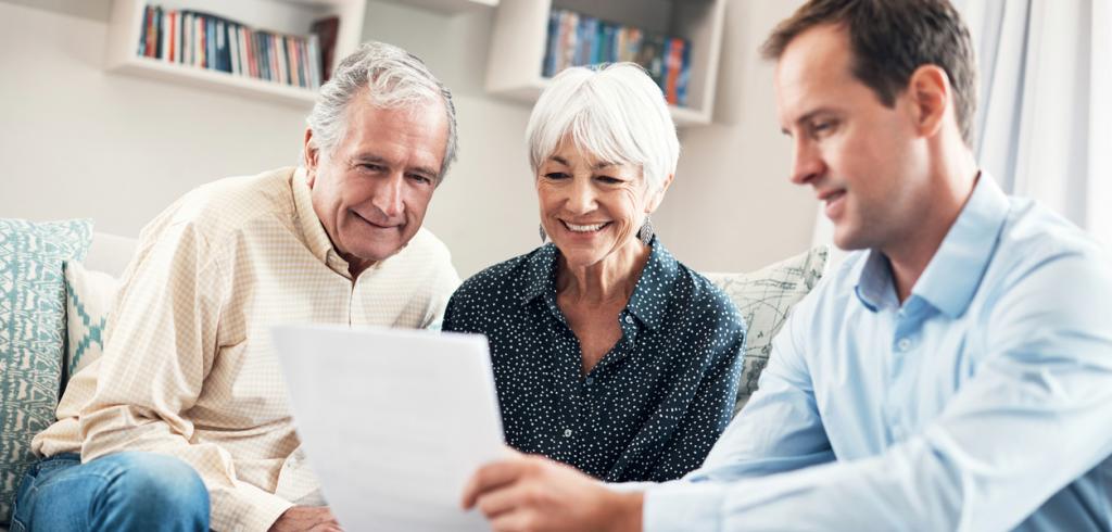 Financial advisor reviewing financial plan with elderly couple Financial advisor reviewing financial plan with elderly couple
