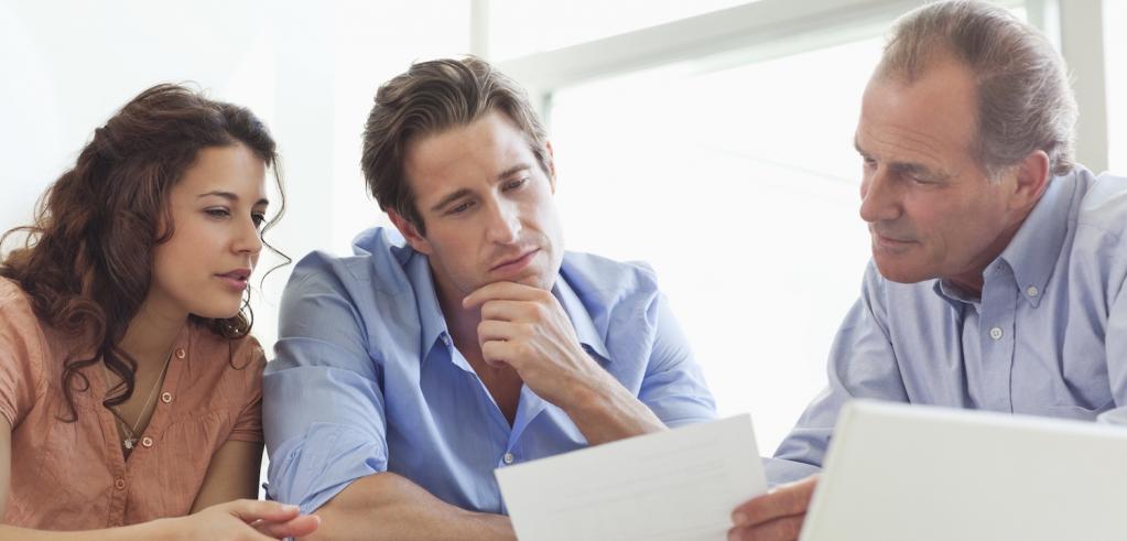 Financial Advisor reviewing retirement plan with clients Financial Advisor reviewing retirement plan with clients