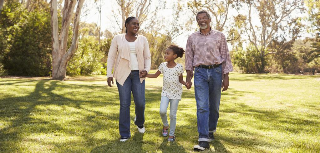 Grandparents and granddaughter walking in park Grandparents and granddaughter walking in park