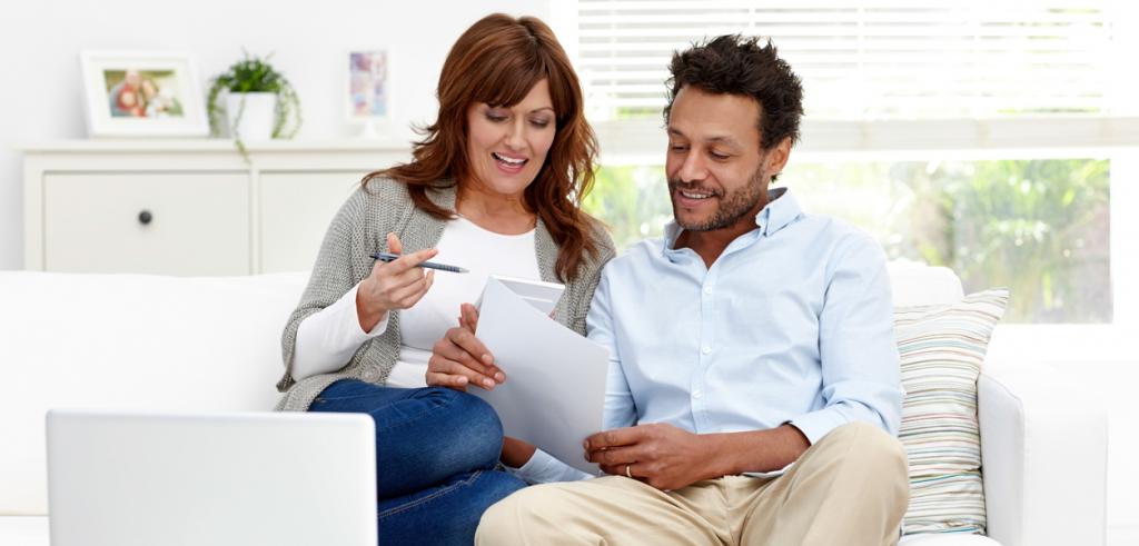 Mixed couple reviewing paperwork