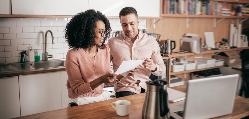 Couple reviewing documents Multi ethnic couple reviewing documents