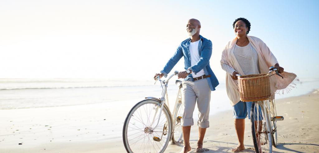Retired couple on beach Retired couple walking along a beach