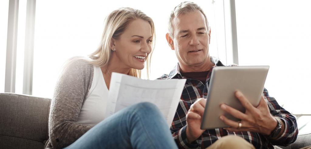 Reviewing finances Middle aged couple looking at their finances