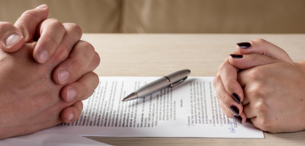 Women and man signing paperwork Women and man signing paperwork