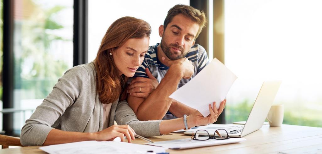 reviewing documents young man and woman looking at documents