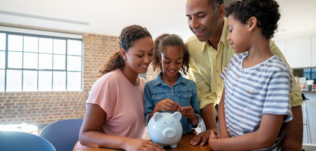 Young family piggy bank Young family gathering around piggy bank