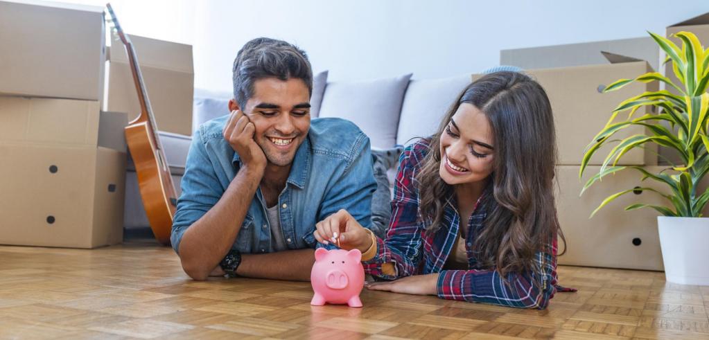 young couple People putting money into piggy bank
