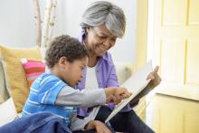 African American grandmother reading with grandson