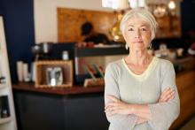 Retired woman standing in living room