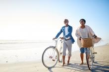 Retired couple walking along a beach