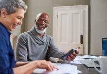 Retired couple reviewing financial statements and wealth plan