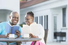 Retired couple spending time together by the pool at vacation property