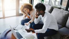Stressed couple reviewing financial statement