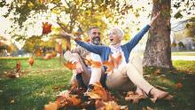 retired man and woman sitting in the park