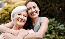 Adult daughter embracing mother